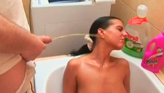 Perverted guy is pissing on Silvia's face in the bathroom porn pics