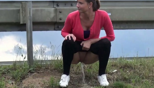 Dark haired shy sweetie pisses at the road side in bushes porn pics