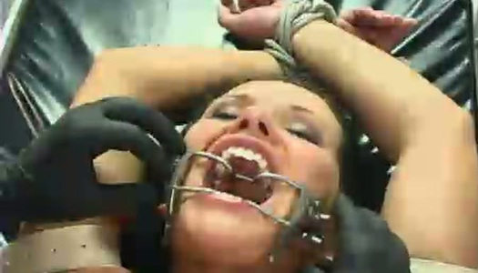 Bald headed dude teases fixed immobilized Katja Kassin's pussy in BDSM way porn pics