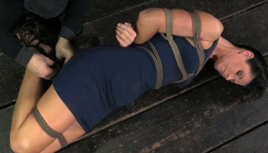 Hard Tied brunette wearing sexy dress lies on the floor porn pics