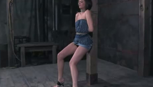 Tied to a pole brunette gets punished in the dark room porn pics