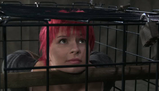 Pink haired sex-slave is sitting in the cage porn pics