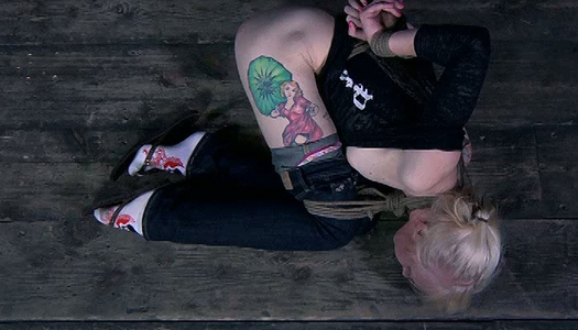 Chick with tattoo on her hip is tied up and fucked with stick porn pics