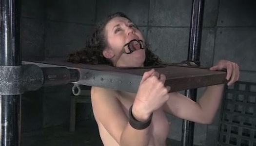 This trashy looking chick is locked in the pillory in this hot BDSM video porn pics