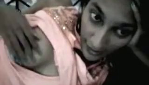 Lying on her bed straight haired slim Indian chick tries to show her tits porn pics