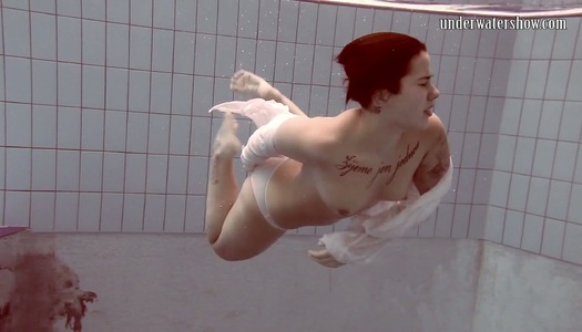 Tempting babe with a nice ass Sara Bombina is stripping under the water porn pics