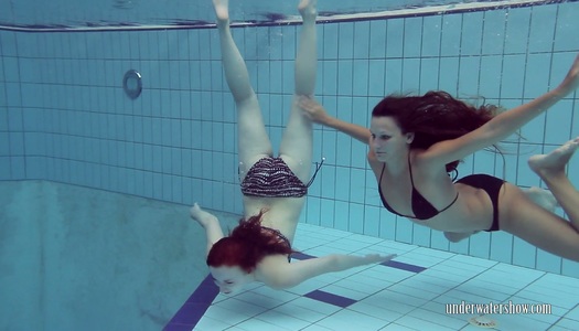Two naughty babes undress under the water and does tricks porn pics