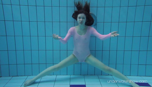 Sexy red haired swimming babe Roxalana Cheh is stripping under the water porn pics