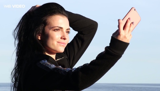 Pretty hot brunette Sapphira is flashing her tits on the rocky beach porn pics