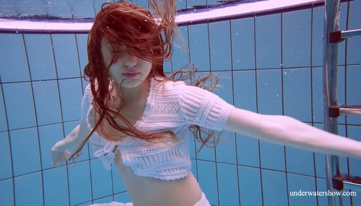 Stunning red haired porn model Marketa shows striptease under the water porn pics