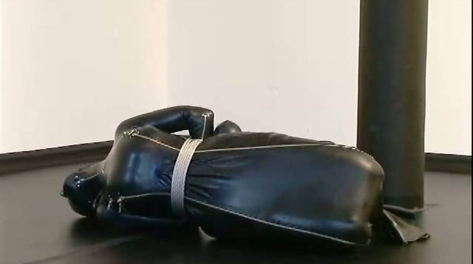 Busty porn model in rubber costume is tied up on the floor - 5. pic