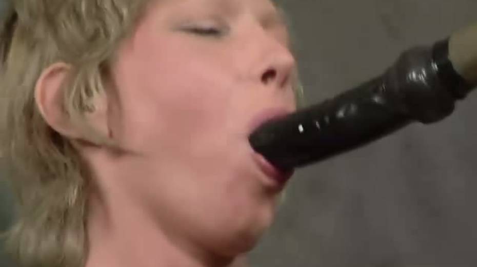 Chick sucks dildo on the stick sitting on the cold floor - 4. pic
