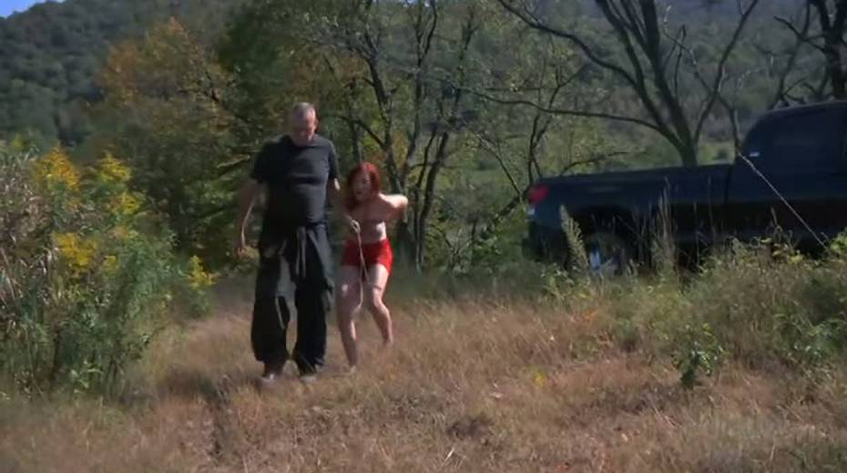 Nasty red head with tied up boobs is punished outdoor - 2. pic