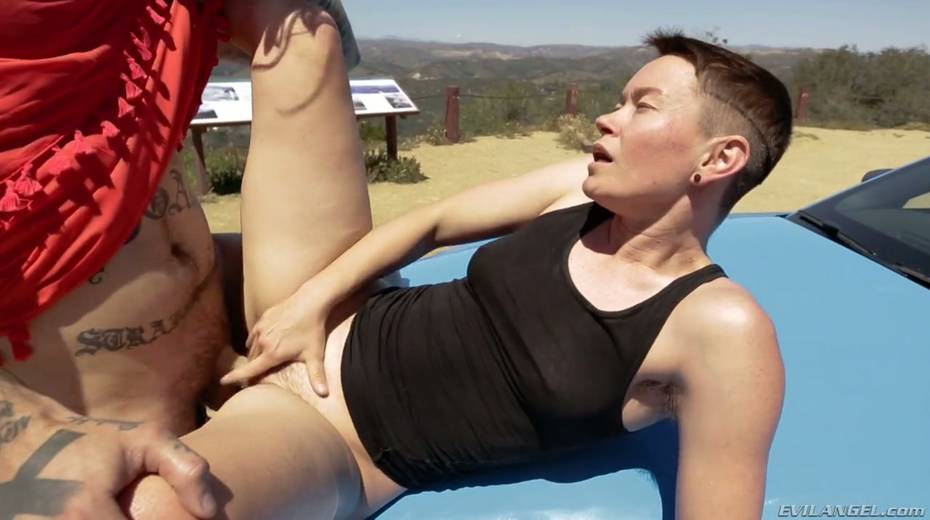 Short haired dyke Jiz Lee is fucked hard by tattooed crossdresser right on the car hood - 23. pic