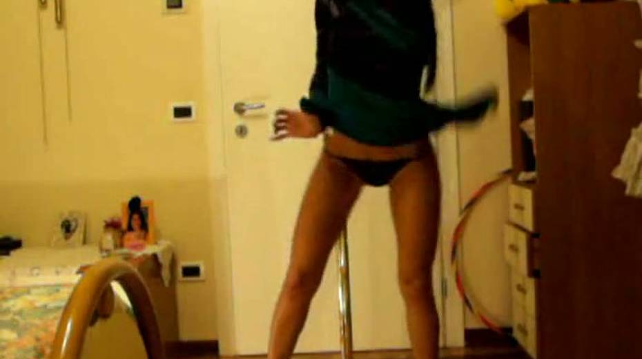 Good looking chick is dancing topless around the pole - 3. pic